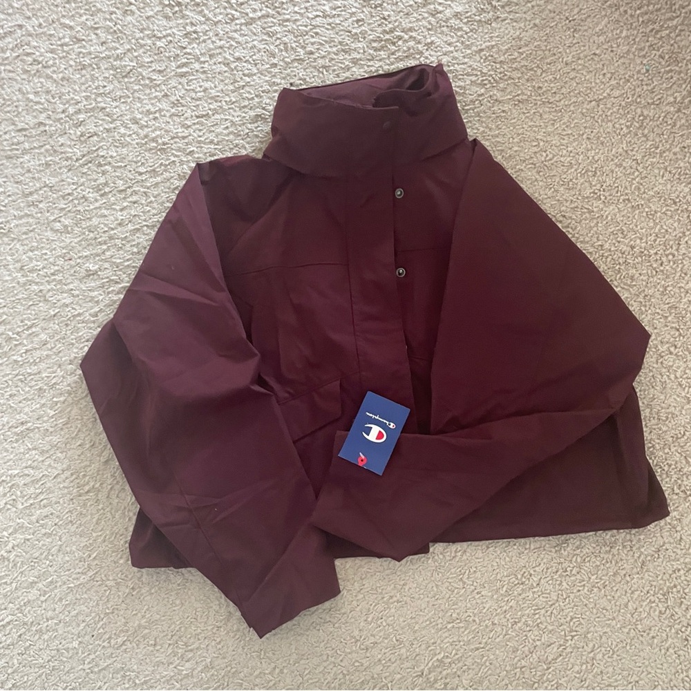 Champions waterproof coat brand new with tag.